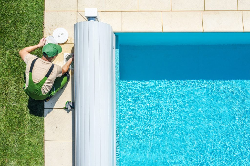 Aerial view of outdoor swimming pool skimmer filter during cleaning