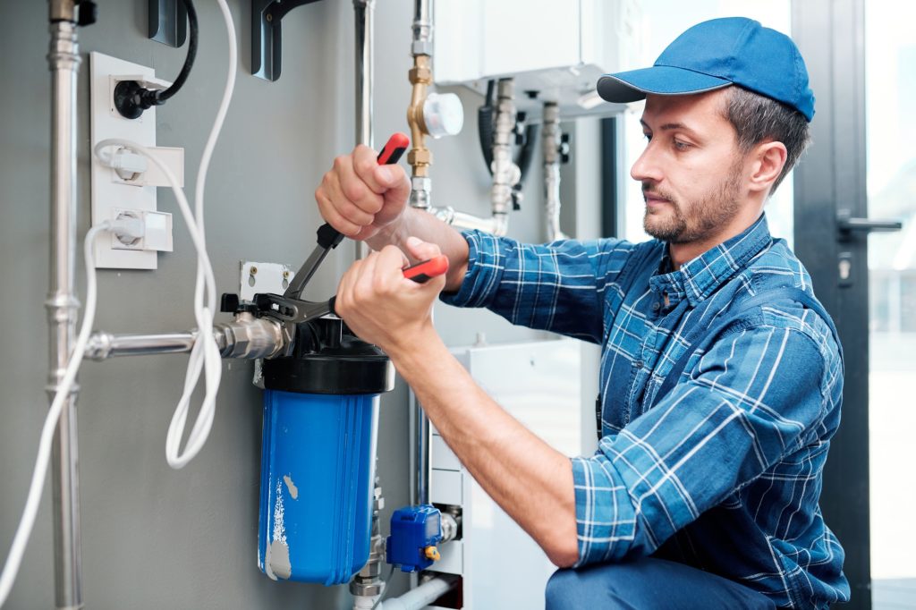 Professional technician maintaining a pool water filtration system