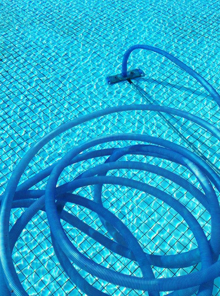 Technician cleaning tubes inside a swimming pool system